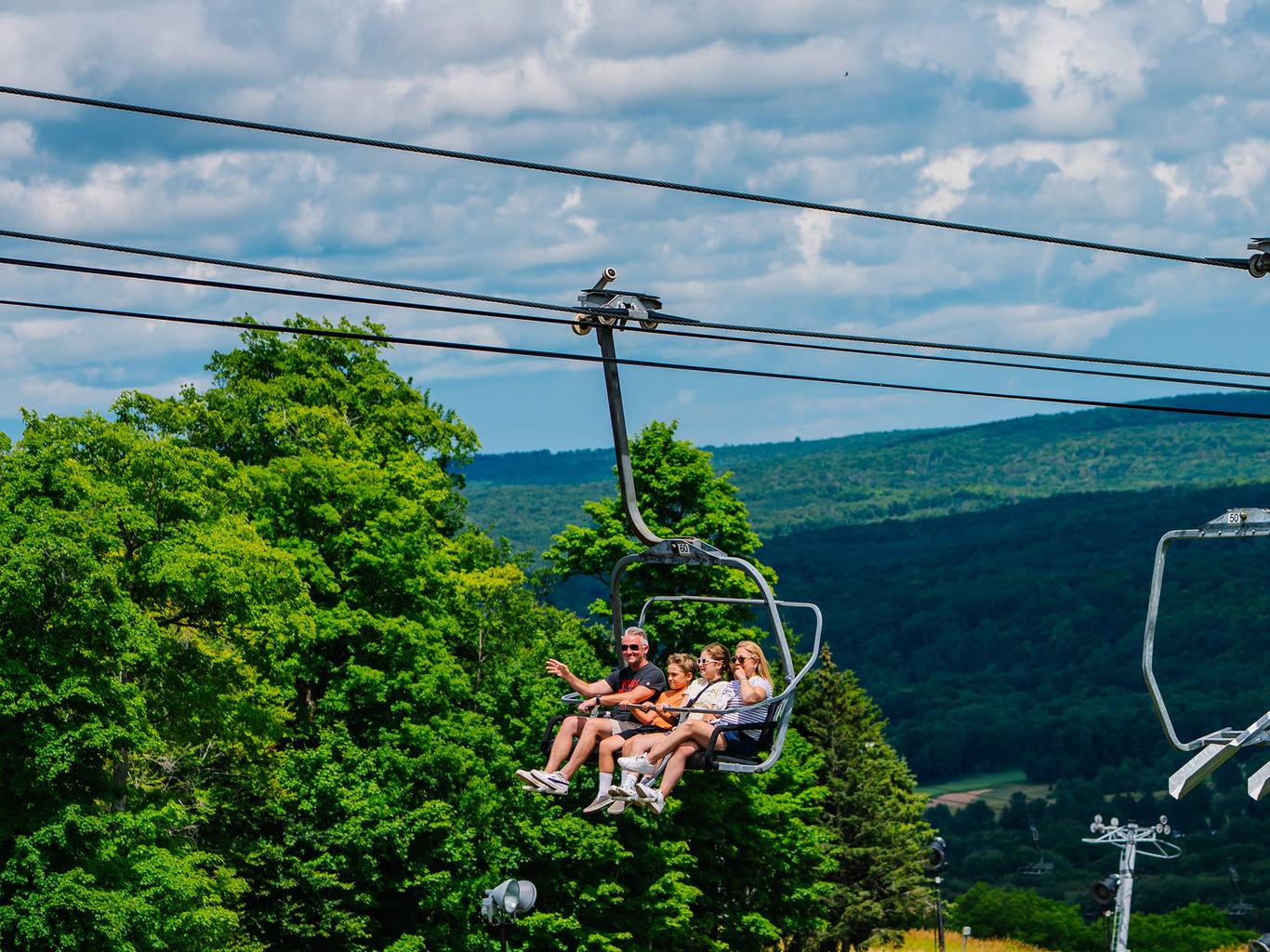 A family on a scenic chairlift ride at The Highlands