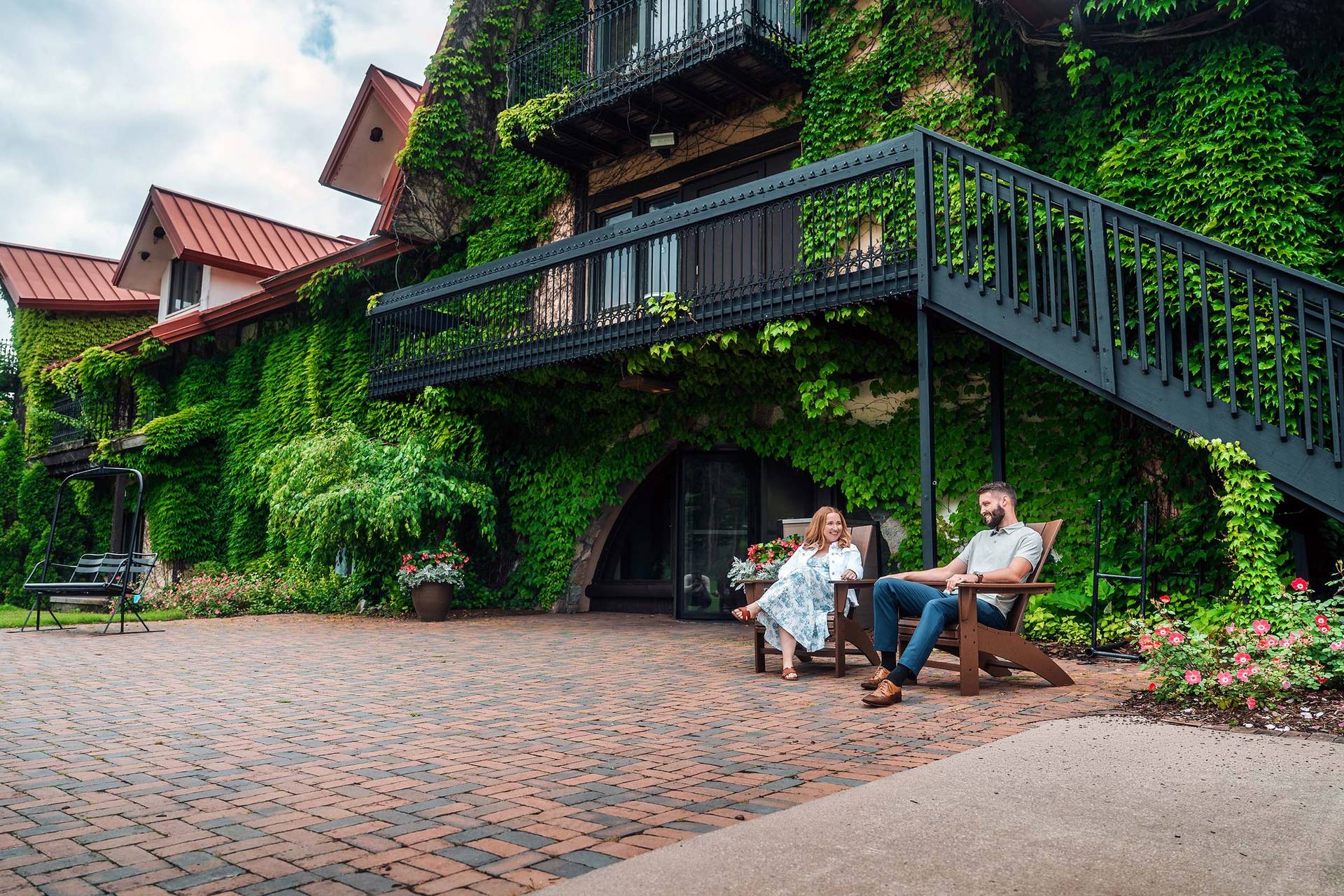 A couple sitting on chairs by the Main Lodge at The Highlands