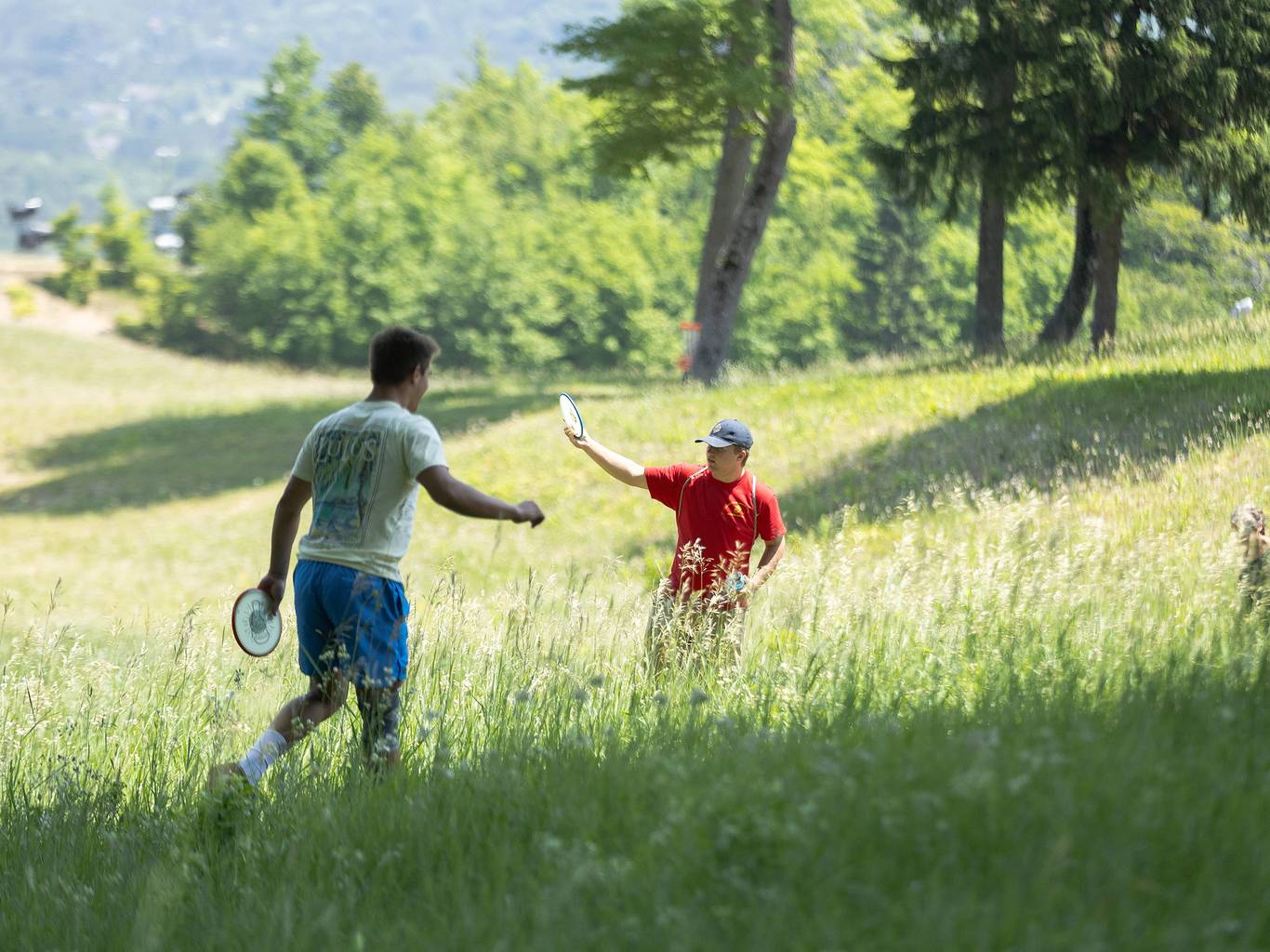 Two men playing disc golf at The Highlands