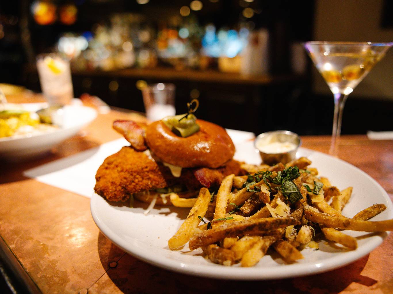 A burger and fries inside Slopeside Lounge at The Highlands