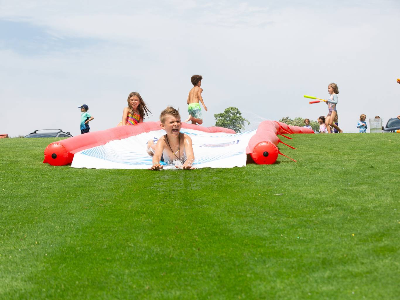 Kids sliding down a slip and slide at The Highlands