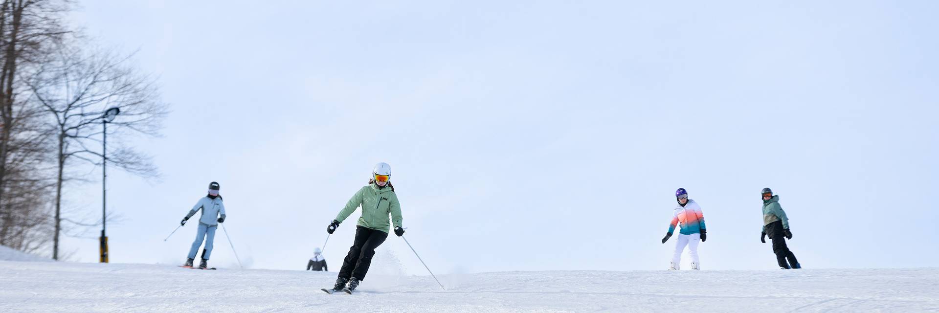 A group of skiers skiing down the slope