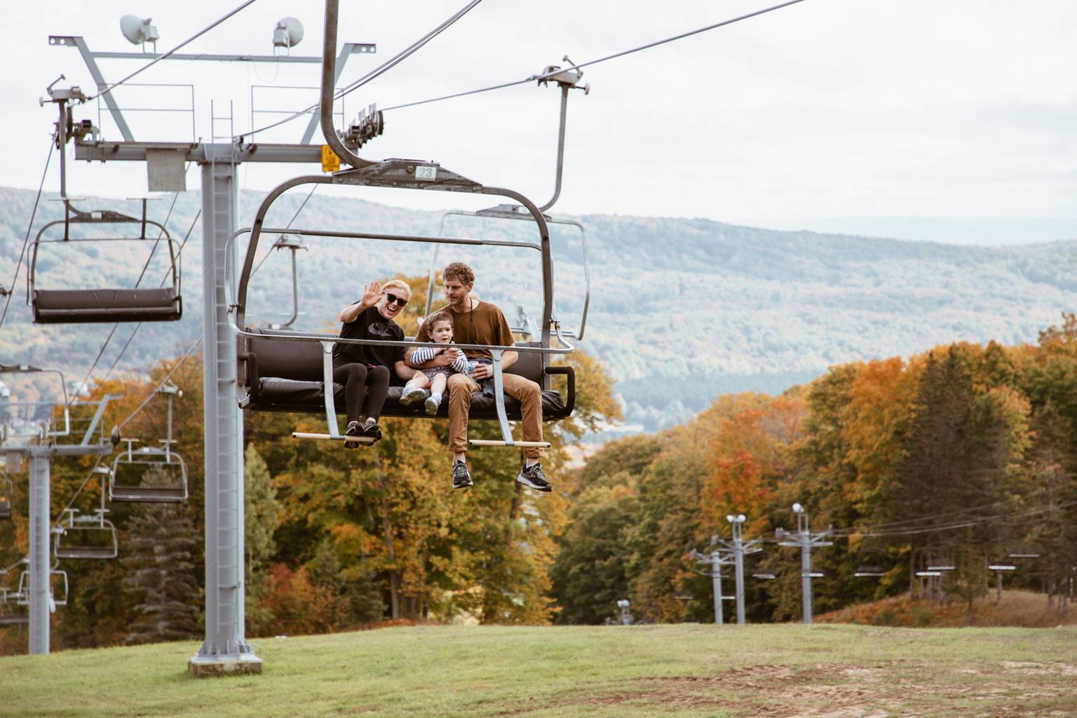 A family posing on a scenic chairlift ride at The Highlands