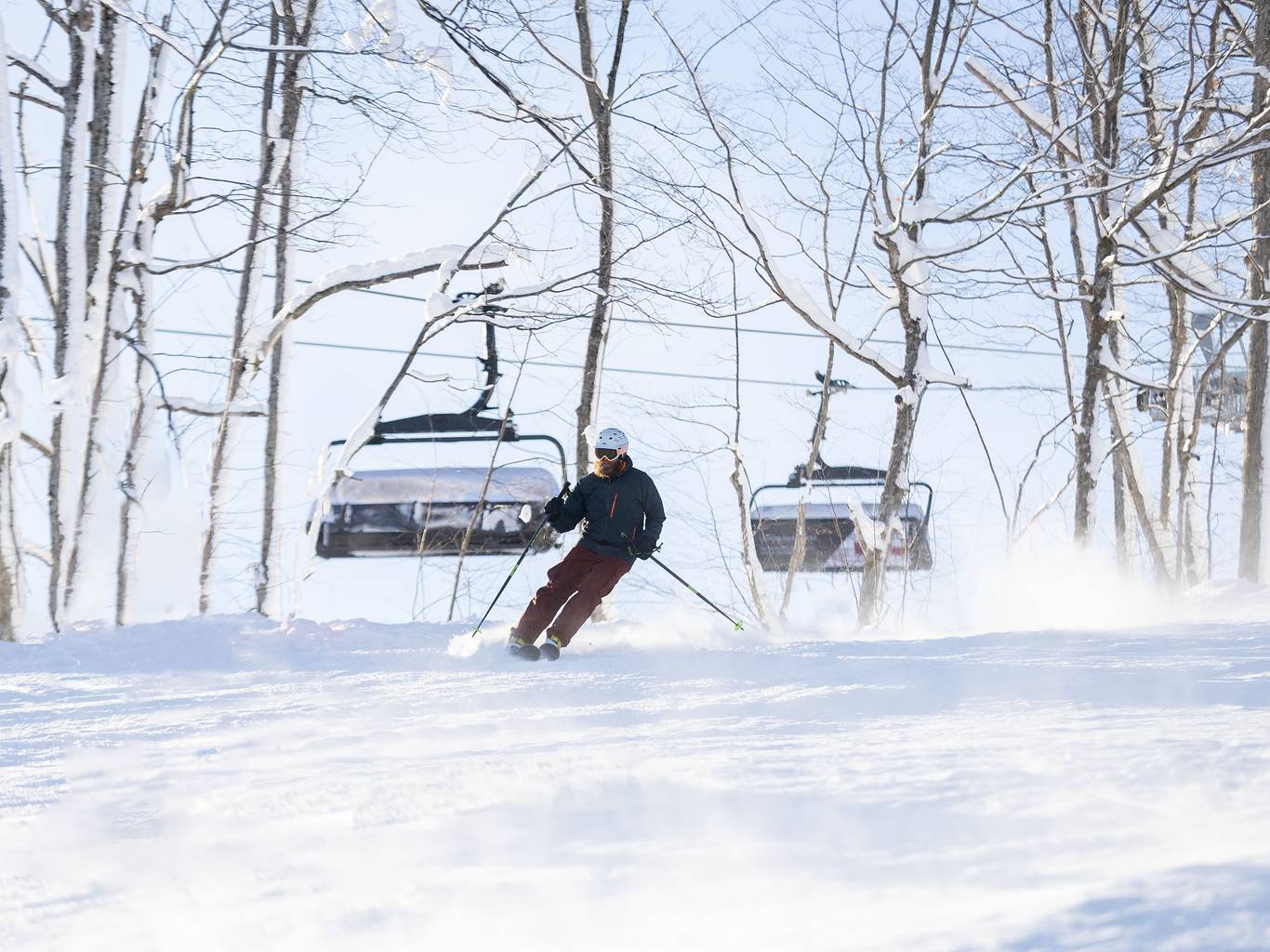 A skier skiing near Camelot 6 at The Highlands