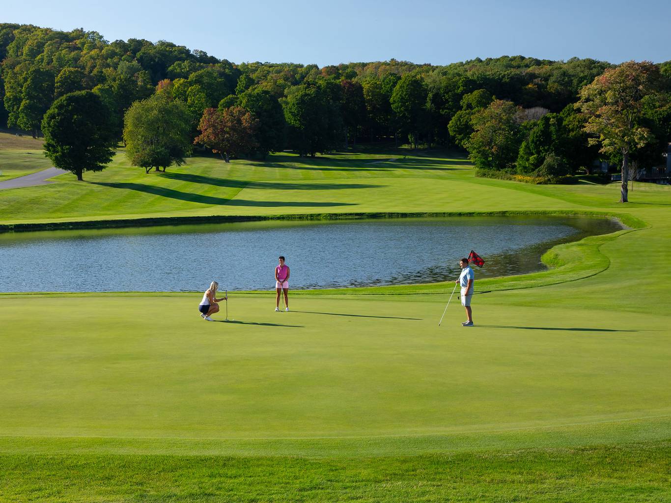 A group of golfers playing on The Heather course