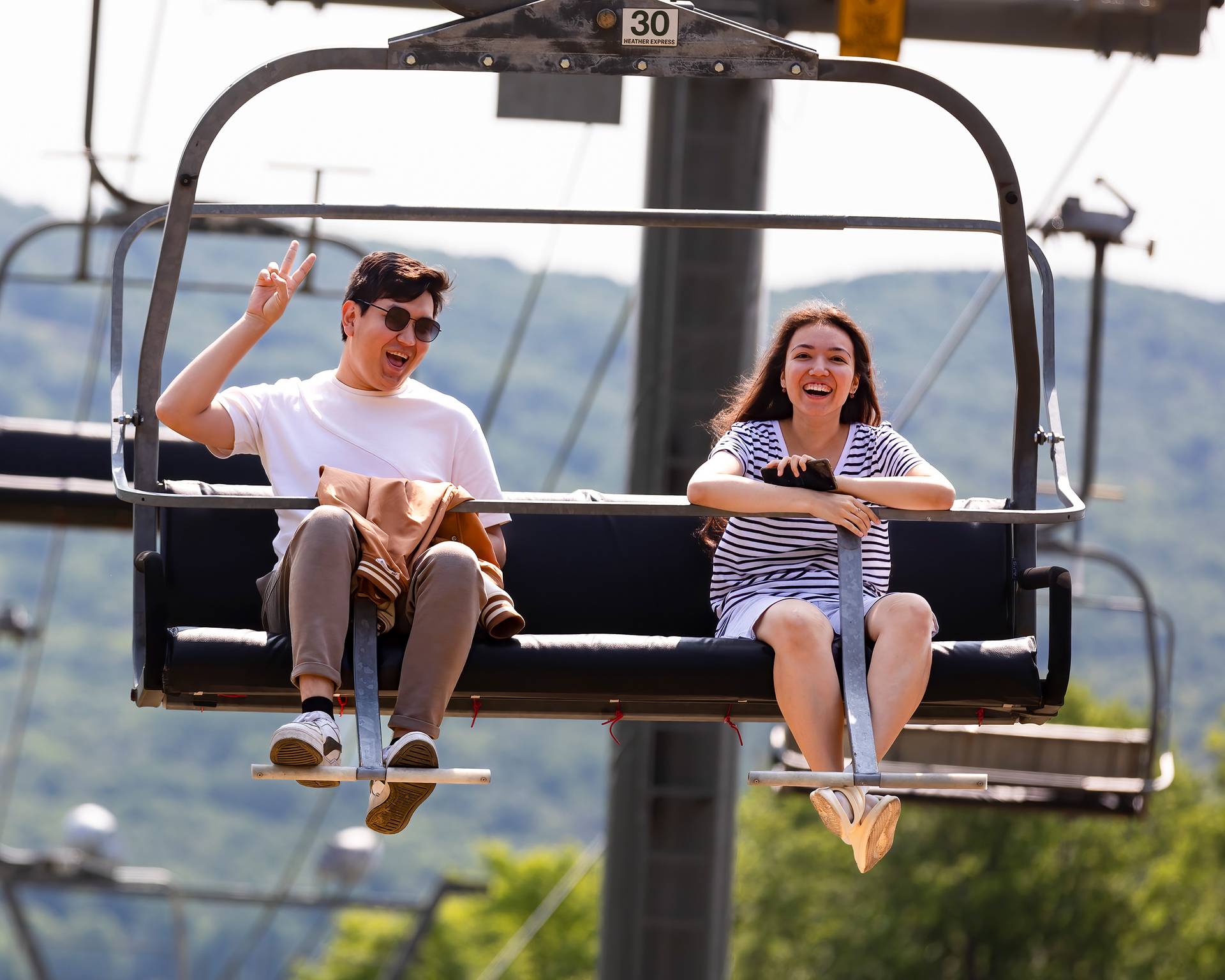 A couple posing on a scenic chairlift ride at The Highlands.