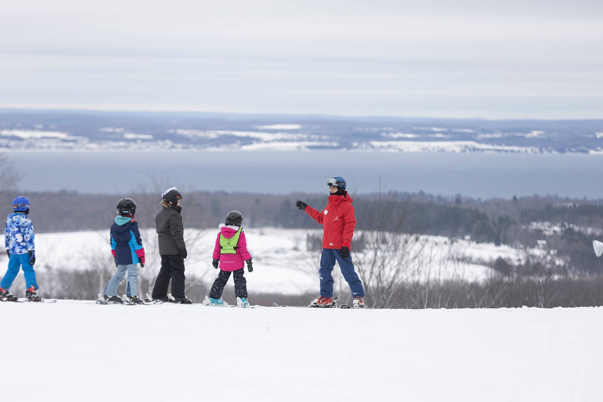 A group of snowsports instructors with kids at The Highlands